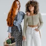 Two fashionable women with grocery items embodying eco-friendly lifestyle.