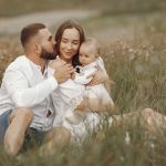 Happy family enjoying quality time in a serene meadow setting.