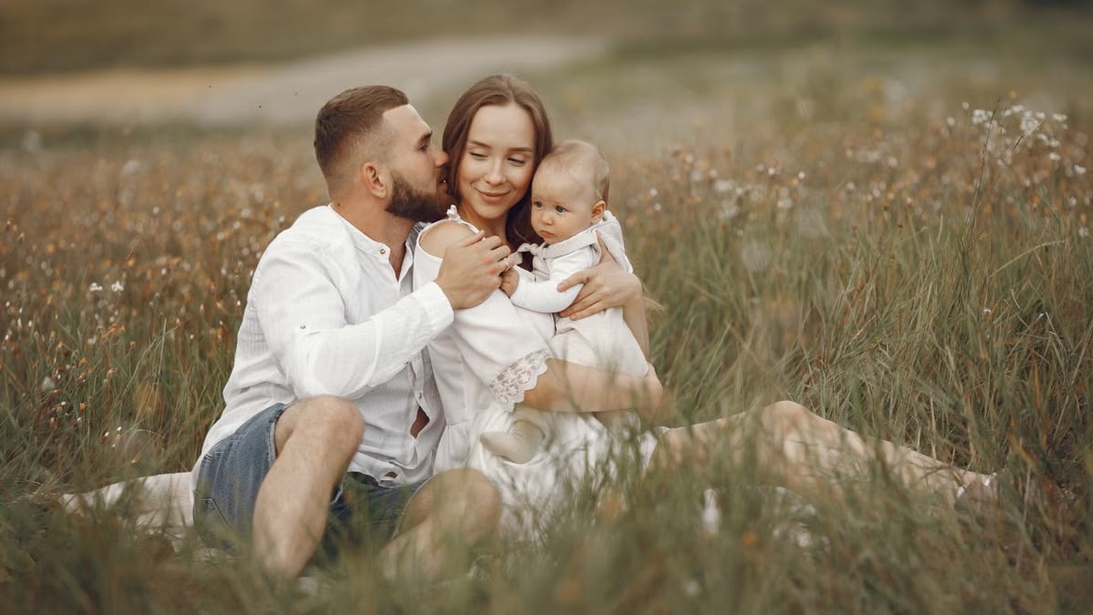Happy family enjoying quality time in a serene meadow setting.